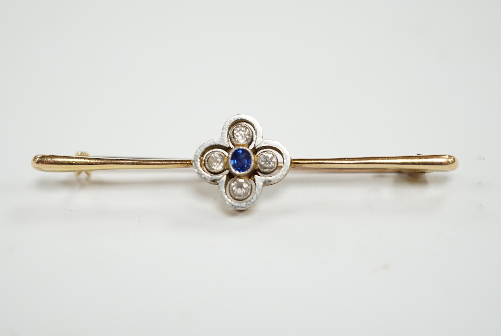 An Edwardian 15ct, sapphire and simulated diamond set four stone bar brooch, 55mm, gross weight 4.9 grams.